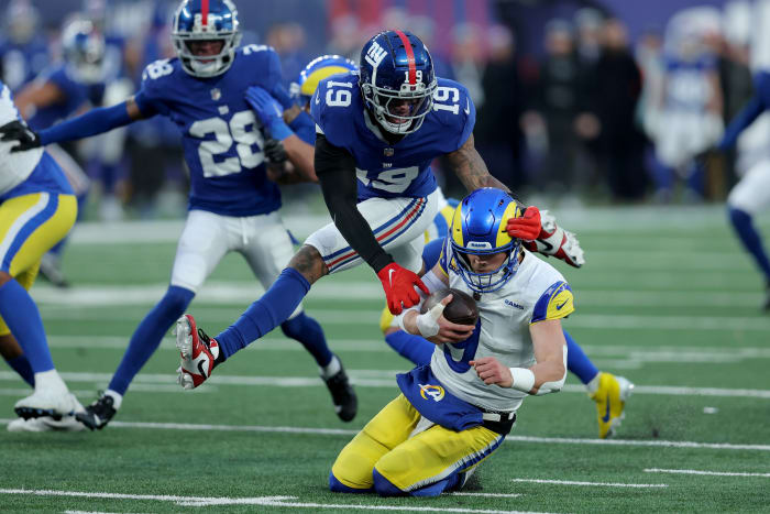 Dec 31, 2023; East Rutherford, New Jersey, USA; Los Angeles Rams quarterback Matthew Stafford (9) is sacked by New York Giants safety Isaiah Simmons (19) during the fourth quarter at MetLife Stadium.